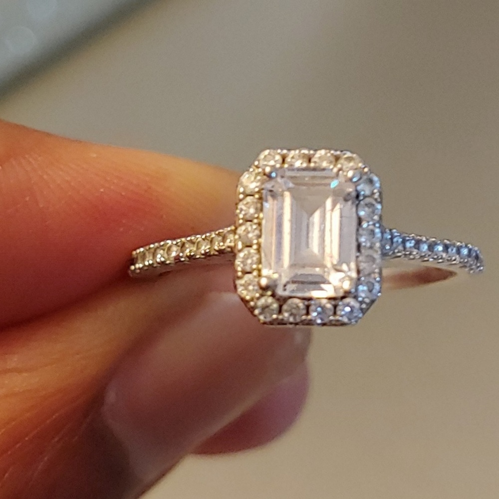 Emerald cut w/round diamonds ring